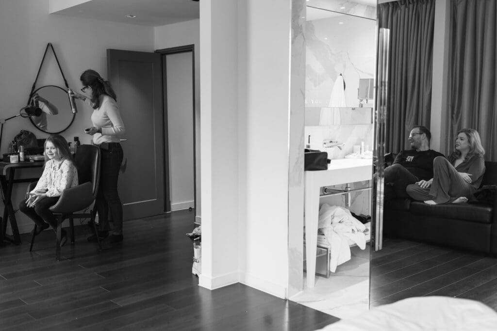 young girl reacting during bridal preparations at Holmes Hotel London before intimate Marylebone Town Hall wedding