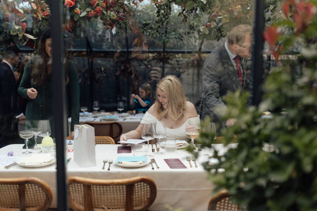 the bride sat down quietly for dinner at the Greenhouses