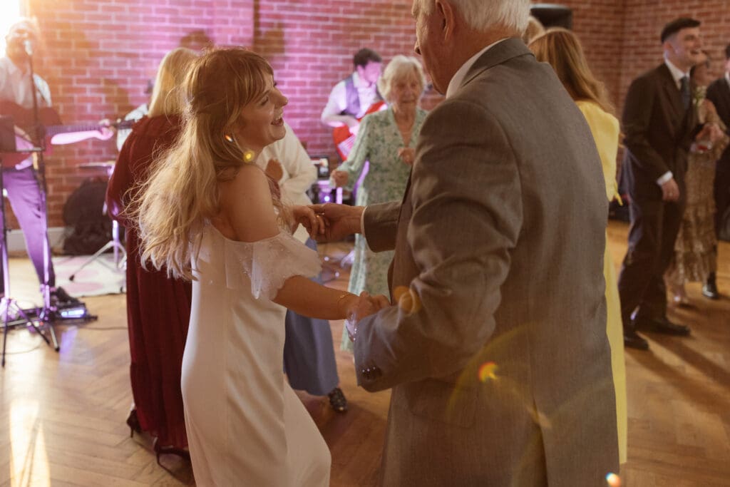 Emotional father-daughter dance during lively wedding reception with live band at Stockton House Shropshire