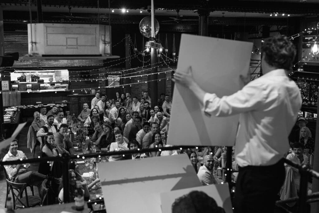 Best man holding presentation boards during a wedding speech at The Depot.