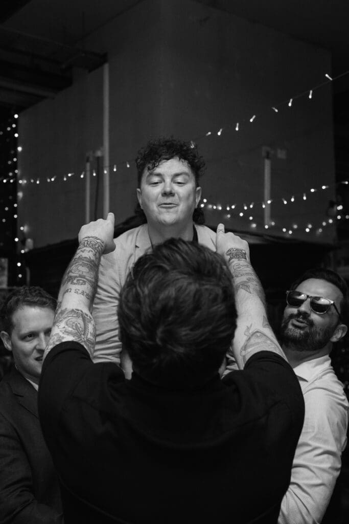 Guest being lifted into the air on the dance floor during a wedding celebration at The Depot.