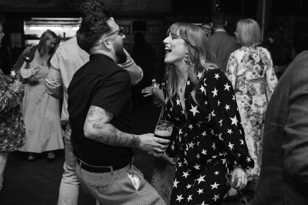 Guests laughing and dancing together during the evening reception at The Depot.